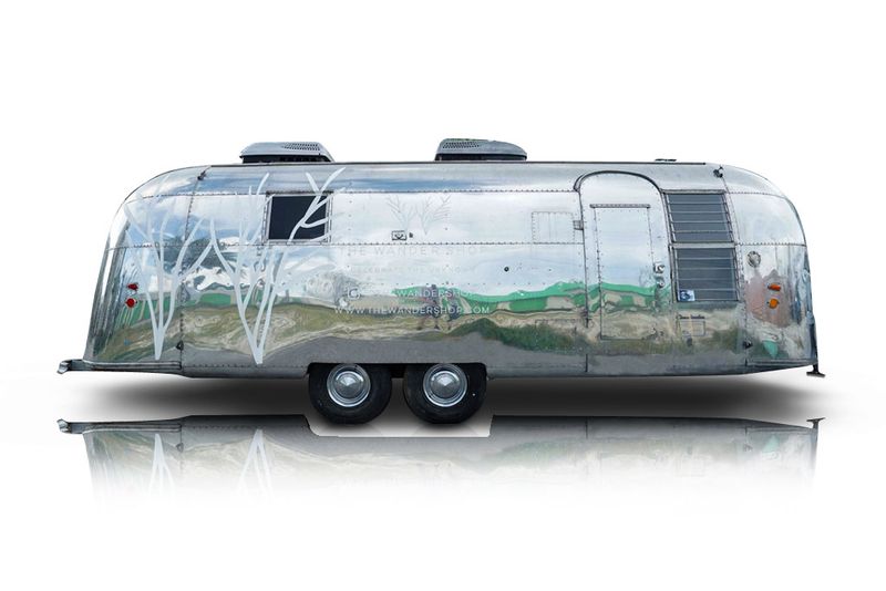 An incredible side shot photo of aAirstream Overlander that you should buy.