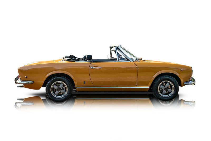 An incredible side shot photo of aFiat 124 Spider that you should buy.