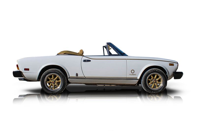 An incredible side shot photo of aFiat 124 Spider that you should buy.