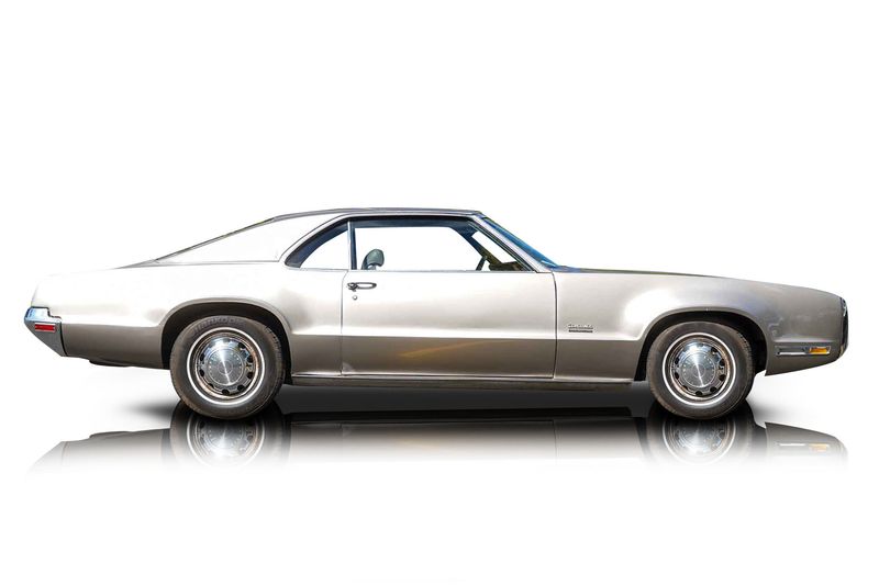 An incredible side shot photo of aOldsmobile Toronado that you should buy.