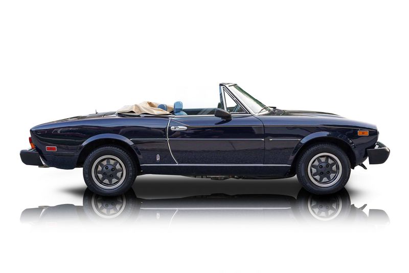 An incredible side shot photo of aFiat 124 Spider that you should buy.