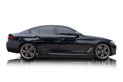 Passenger side photo of 2022 BMW M550i xDrive