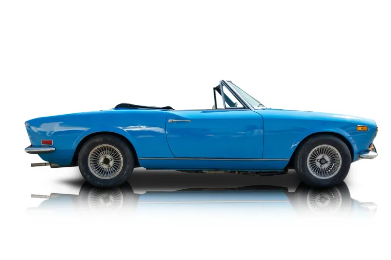 An incredible side shot photo of aFiat 124 Spider that you should buy.