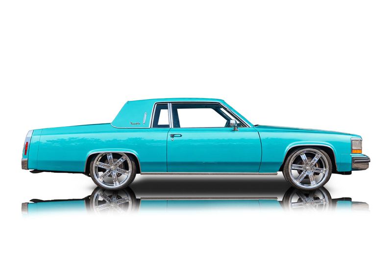An incredible side shot photo of aCadillac DeVille that you should buy.